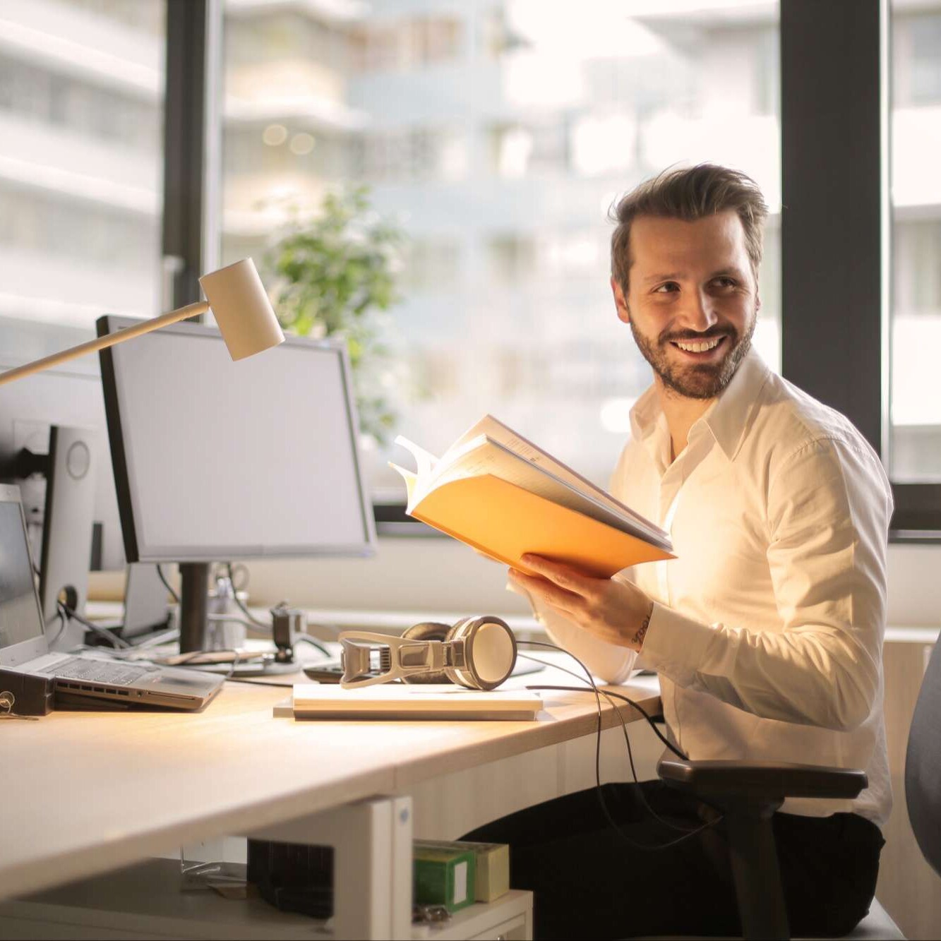 happy corporate business man at work smiling