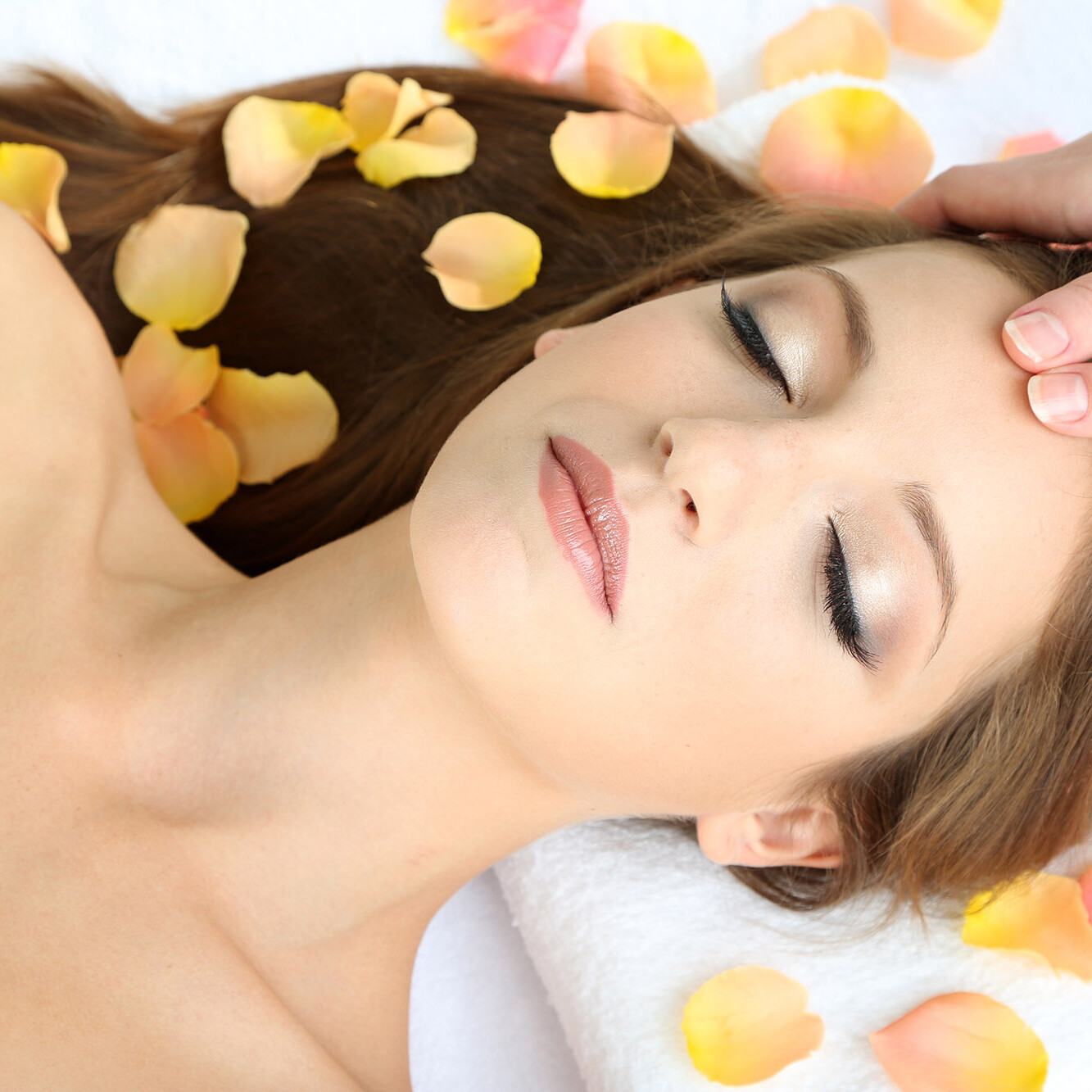 photo of woman being treated with facial massage